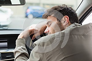Drunk man slumped on steering wheel photo