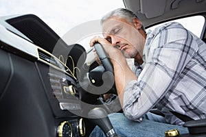 Drunk man slumped on steering wheel photo