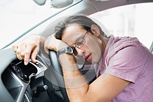 Drunk man slumped on steering wheel photo