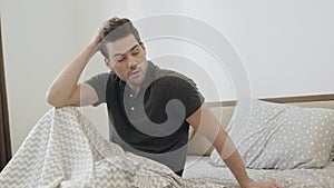 Drunk man trying to remember party night. Sleepy man waking up in bedroom.