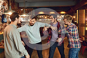 Drunk people are fighting in a pub. photo