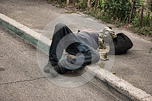 Drunk person lying outdoors.