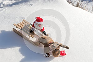 Drunk Santa Claus with empty bottle on the sled