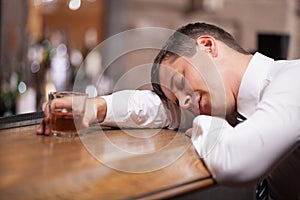 Drunk and unconscious businessman lying on counter.