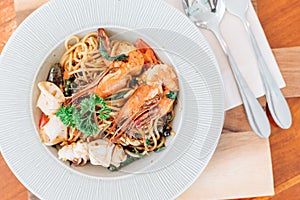 Drunken spaghetti with seafood on white plate is modern Thai fusion food