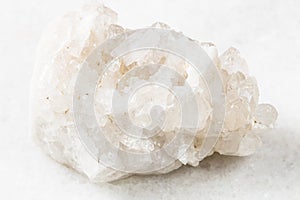 druse of colorless rock-crystal on white marble