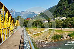 Drusus bridge in Bolzano passing river Talvera with the Dolomites Italian Alps on the background, Italy