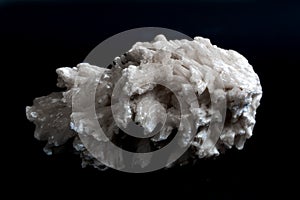 Drusus gypsum. white stone on a black background