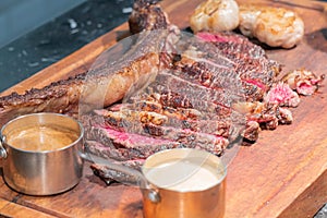 Dry-aged marble beef steak Tomahawk on wooden board with spices. Close-up, dinner concept