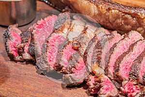 Dry-aged marble beef steak Tomahawk on wooden board with spices. Close-up, dinner concept