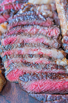 Dry-aged marble beef steak Tomahawk on wooden board with spices. Close-up, dinner concept