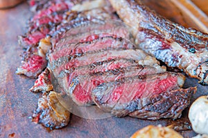 Dry-aged marble beef steak Tomahawk on wooden board with spices. Close-up, dinner concept