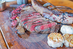 Dry-aged marble beef steak Tomahawk on wooden board with spices. Close-up, dinner concept