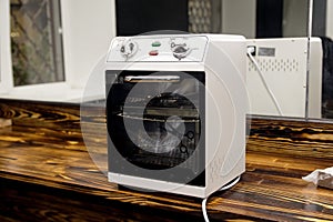 Dry-air sterilizer standing on a table for processing tools in a beauty salon