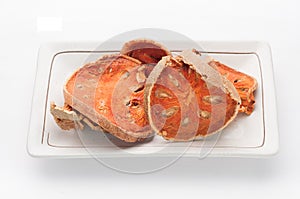 Dry Bael Fruit tea (Aegle marmelos) isolated on dish and white b