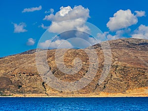 Dry barren hills bordering the sea photo