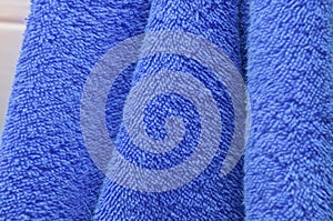 Dry bath towels are blue in the bathroom