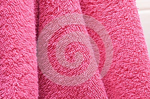 Dry bath towels are pink in the bathroom