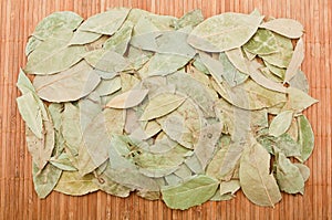 Dry bay leaf on a bamboo mat, can be used as texture.