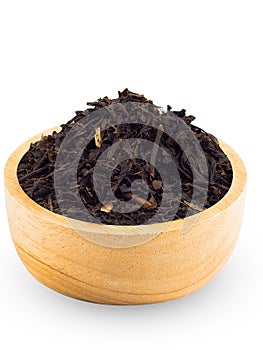 Dry Black Tea Leaves in wood cup with white background.