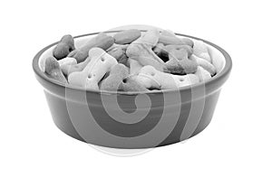 Dry bone-shaped dog biscuits in a pet food bowl