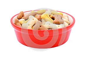 Dry bone-shaped dog biscuits in a red pet food bowl