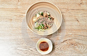 Dry braised pork and ball with bean sprout on bowl dipping spicy sauce