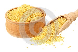 dry bulgur wheat in wooden bowl isolated on white background. top view