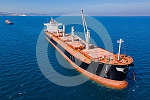 Dry cargo ship on bulk vessel in anchorage in sea