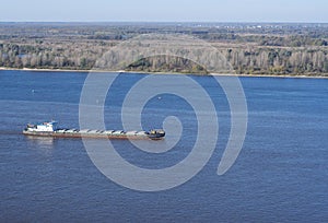 Dry-cargo ship loaded floats down the Volga river