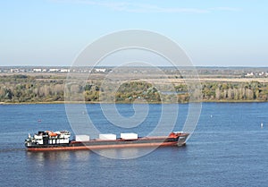 Dry-cargo ship loaded floats down the Volga river