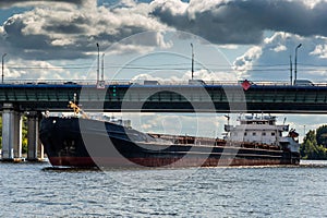 Dry cargo ship on the Moscow Canal river in summer day