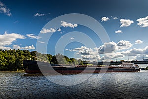 Dry cargo ship on the Moscow Canal river in summer day