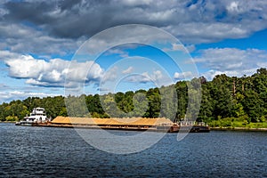Dry cargo ship on the Moscow Canal river in summer day