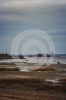 dry cargo ship sailing near the lighthouse