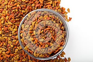 Dry cat dog food in granules. Pet treats in metal bowl