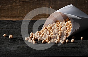 The dry chickpeas on dark wooden desk board. Cicer arietinum. Legume of the family Fabaceae. Egyptian pea