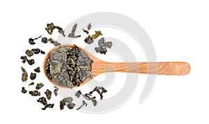 Dry Chinese tea leaves on wooden spoon