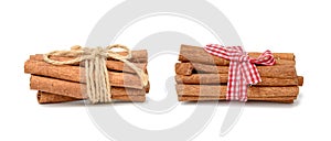 Dry cinnamon sticks tied with red ribbon, spice isolated on white background