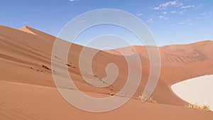 Dry clay pan with red desert sand dunes, Sossusvlei, Namibia