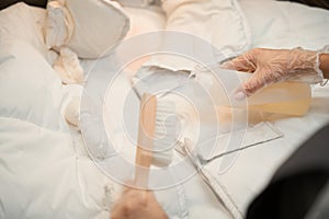 Dry-cleaning office worker applying stain removal agent on white jacket