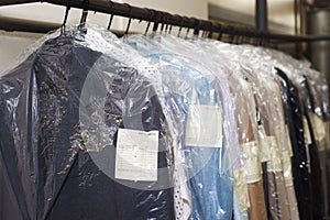 Dry cleaning things hanging in a row