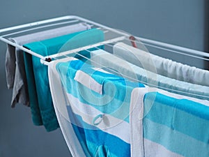 Dry clothes on the dryer in the house after washing. Cleanliness, hygiene.