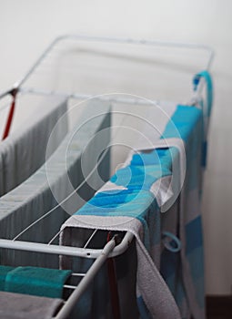 Dry clothes on the dryer in the house after washing. Cleanliness, hygiene.