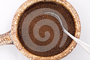 Dry coffee grounds in a bowl.