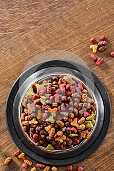 Dry Colorful cat food in metal bowl