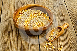 Dry corn grains in bowl for making popcorn