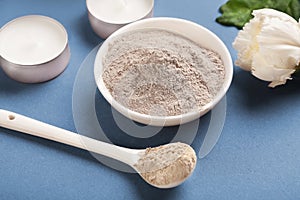 Dry cosmetic mud mask powder in bowl