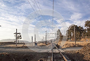 Dry Countryside with Rural Gravel Road Crossing Railway Tracks