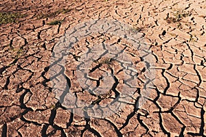 Dry cracked earth background in arid season. Many Province of North East in Thailand the ground dry. Brown cracked soil in the sum